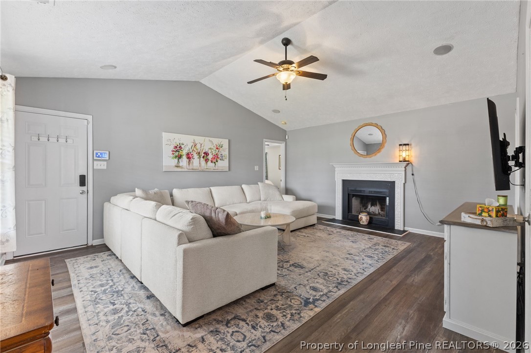 122 Raymond Street Raeford, NC 28376 - Photo 6 of 36 a living room with furniture and a fireplace