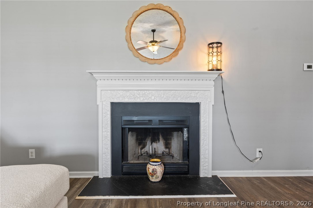 122 Raymond Street Raeford, NC 28376 - Photo 8 of 36 a living room with a fireplace and a potted plant