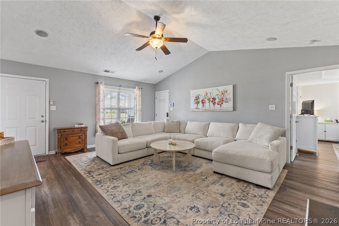 122 Raymond Street Raeford, NC 28376 - Photo 9 of 36 a living room with furniture and a chandelier