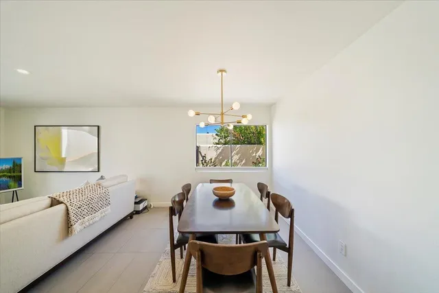 a view of a dining room with furniture and window