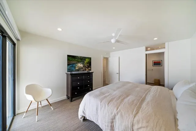 a bedroom with a bed and a chair