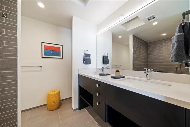 a bathroom with a double vanity sink and a mirror