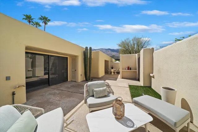 a balcony with furniture and a potted plant