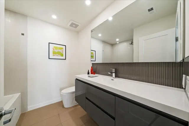 a bathroom with a sink a mirror and a toilet