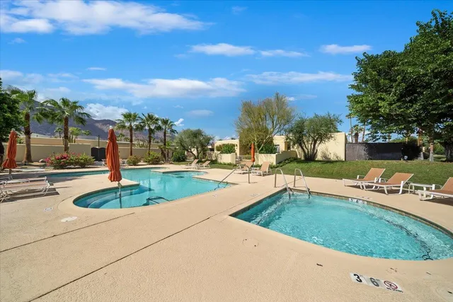 a view of a swimming pool and a yard