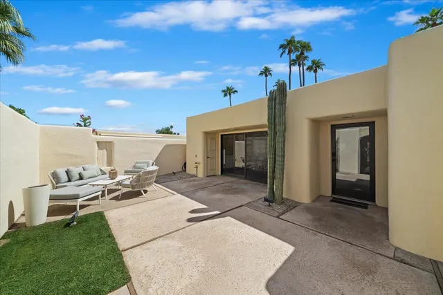 a view of a porch with furniture and a fire pit
