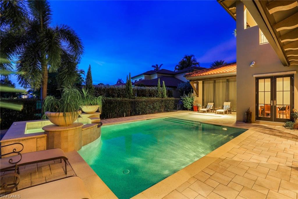 16699 Pistoia Way Naples, FL 34110 - Photo 33 of 48 a view of a backyard with couches plants and large trees