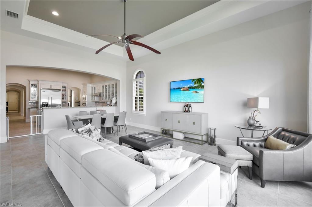 16699 Pistoia Way Naples, FL 34110 - Photo 10 of 48 a living room with furniture and a lamp