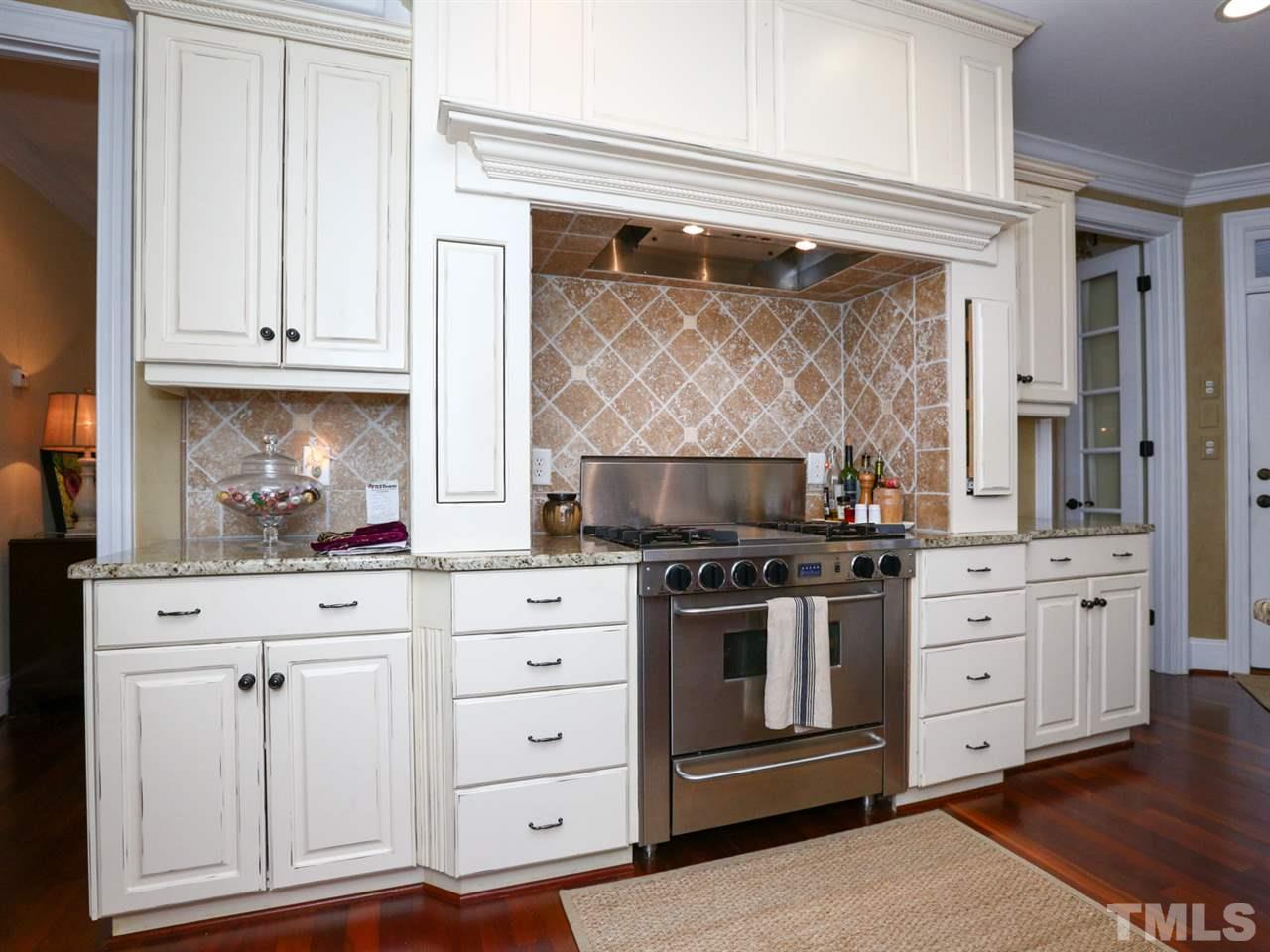 1824 Stannard Trail Raleigh, NC 27612 - Photo 14 of 25 Granite countertops, stainless appliances and many extras, including a custom spice rack hidden above stove, are just a few of the additional touches in this gourmet kitchen.