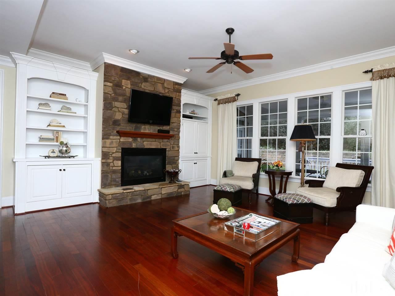 1824 Stannard Trail Raleigh, NC 27612 - Photo 8 of 25 Gorgeous Family room with custom stone fireplace, walls of windows overlooking your private patio, crown molding, built in bookcases and so much more.