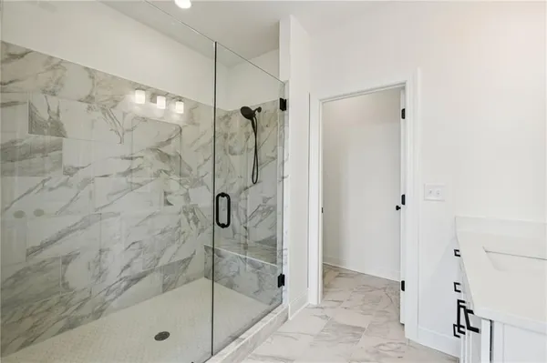 a bathroom with a glass shower door