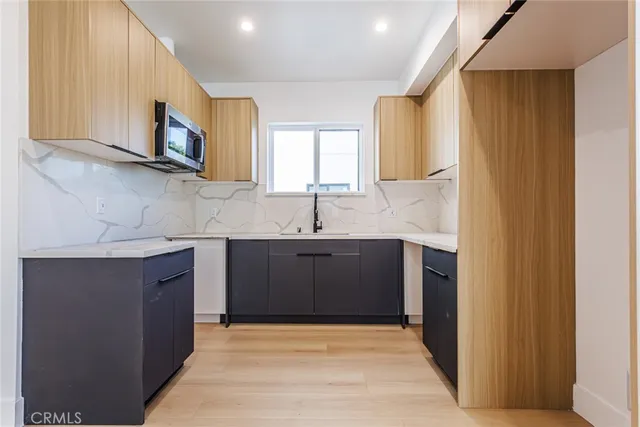 a kitchen with stainless steel appliances granite countertop a sink and a microwave