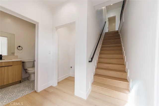 a view of an entryway with wooden floor and a bathroom