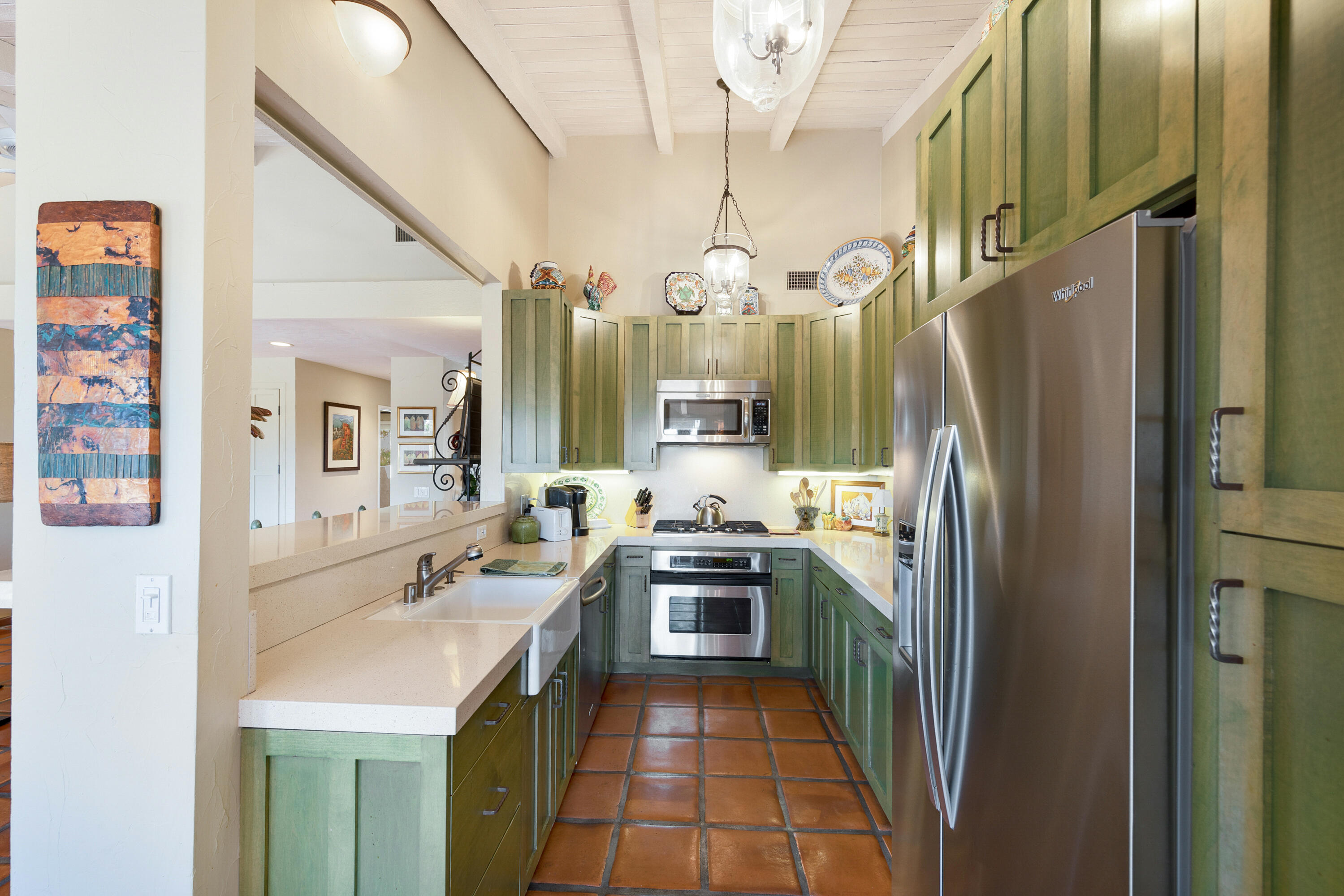 40162 Vía Del Oro Rancho Mirage, CA 92270 - Photo 14 of 34 a kitchen with stainless steel appliances a sink stove and refrigerator