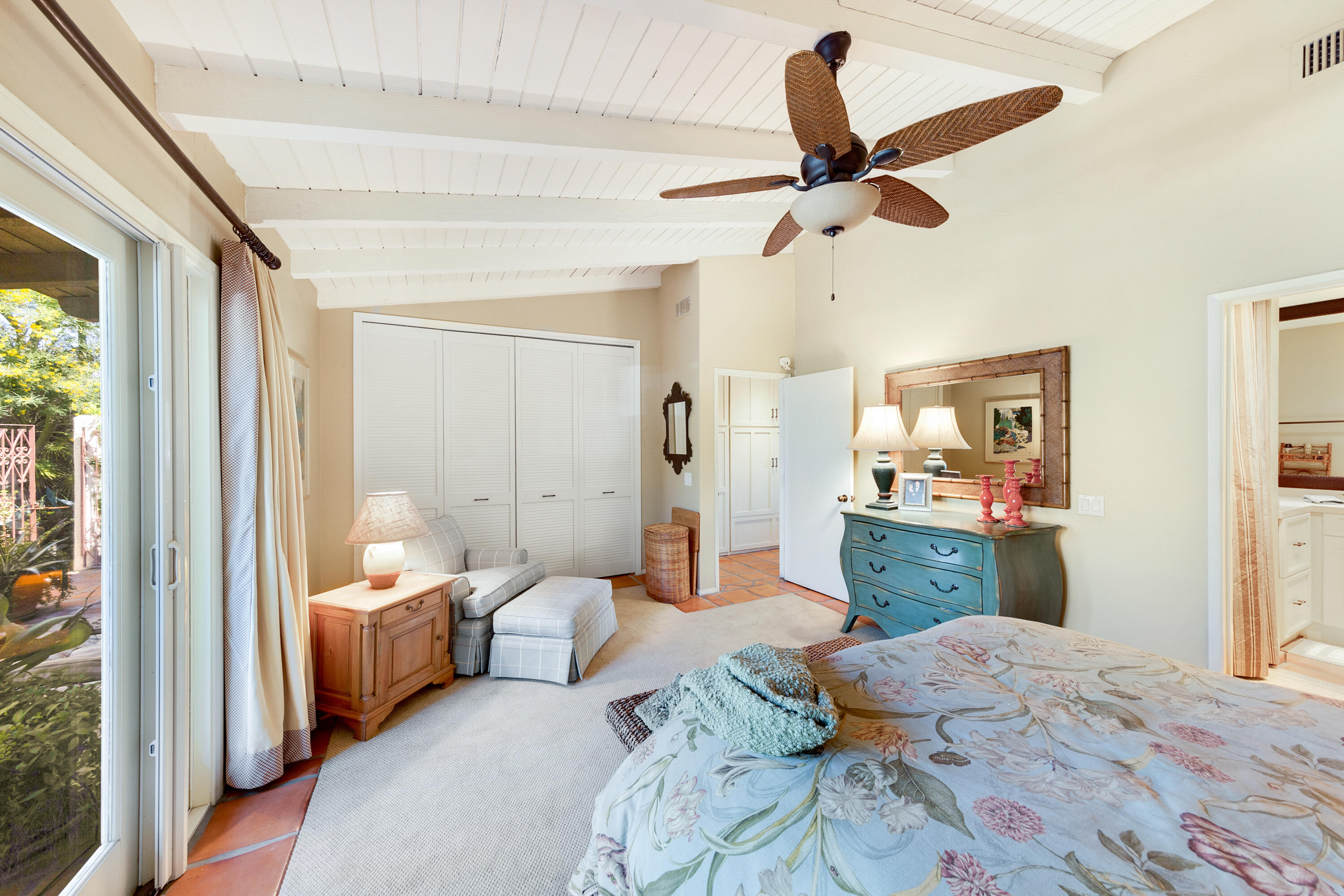 40162 Vía Del Oro Rancho Mirage, CA 92270 - Photo 23 of 34 a bedroom with a bed a couch and a window