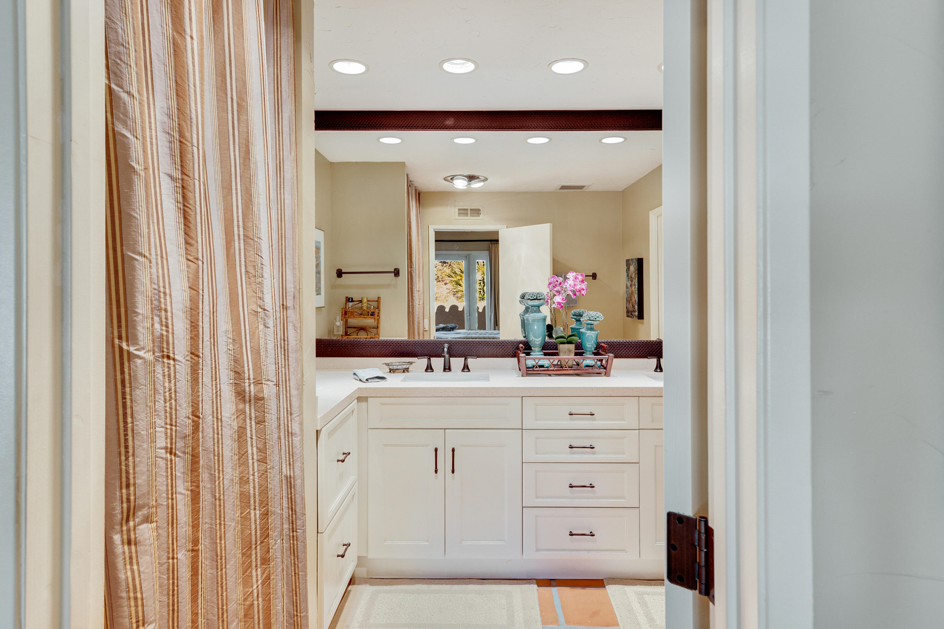 40162 Vía Del Oro Rancho Mirage, CA 92270 - Photo 24 of 34 a bathroom with a sink a large mirror and a shower