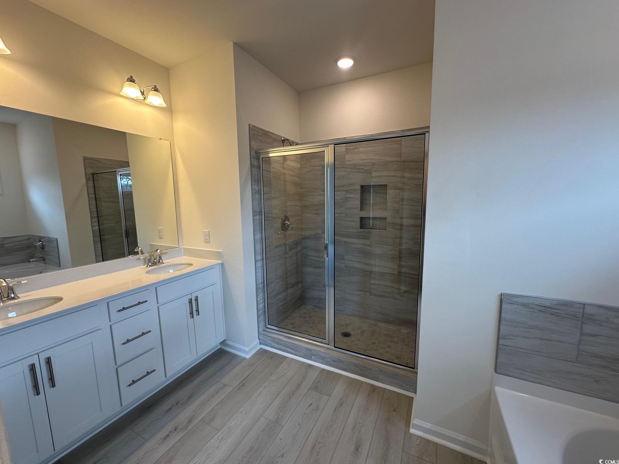 537 Honeyhill Loop Conway, SC 29526 - Photo 13 of 40 Bathroom with a washtub, wood finished floors, a s