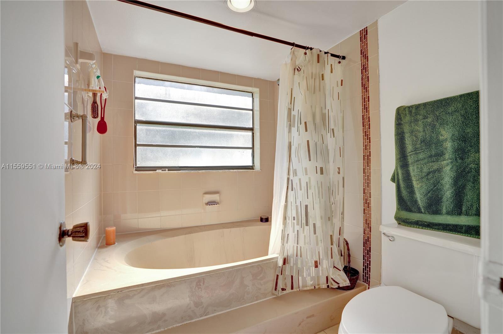 337 Ives Dairy Road, Unit 33704 Miami, FL 33179 - Photo 12 of 22 a bathroom with a tub shower and sink