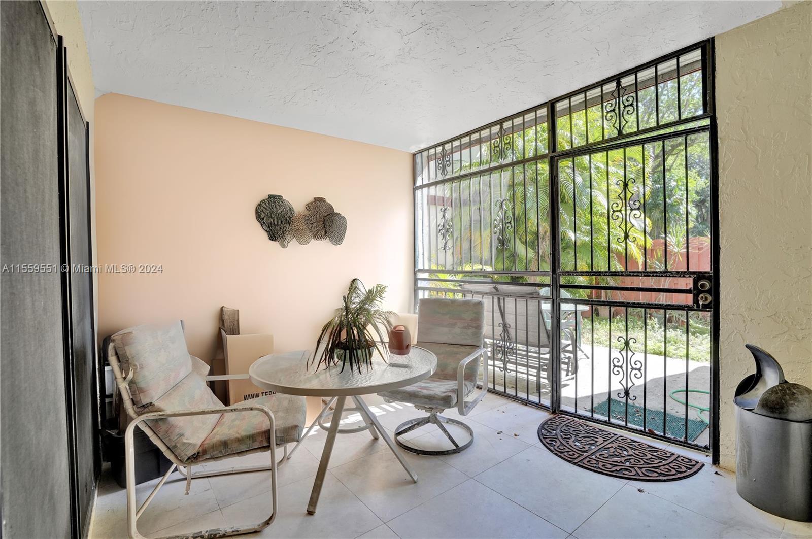 337 Ives Dairy Road, Unit 33704 Miami, FL 33179 - Photo 14 of 22 a living room with furniture and a floor to ceiling window