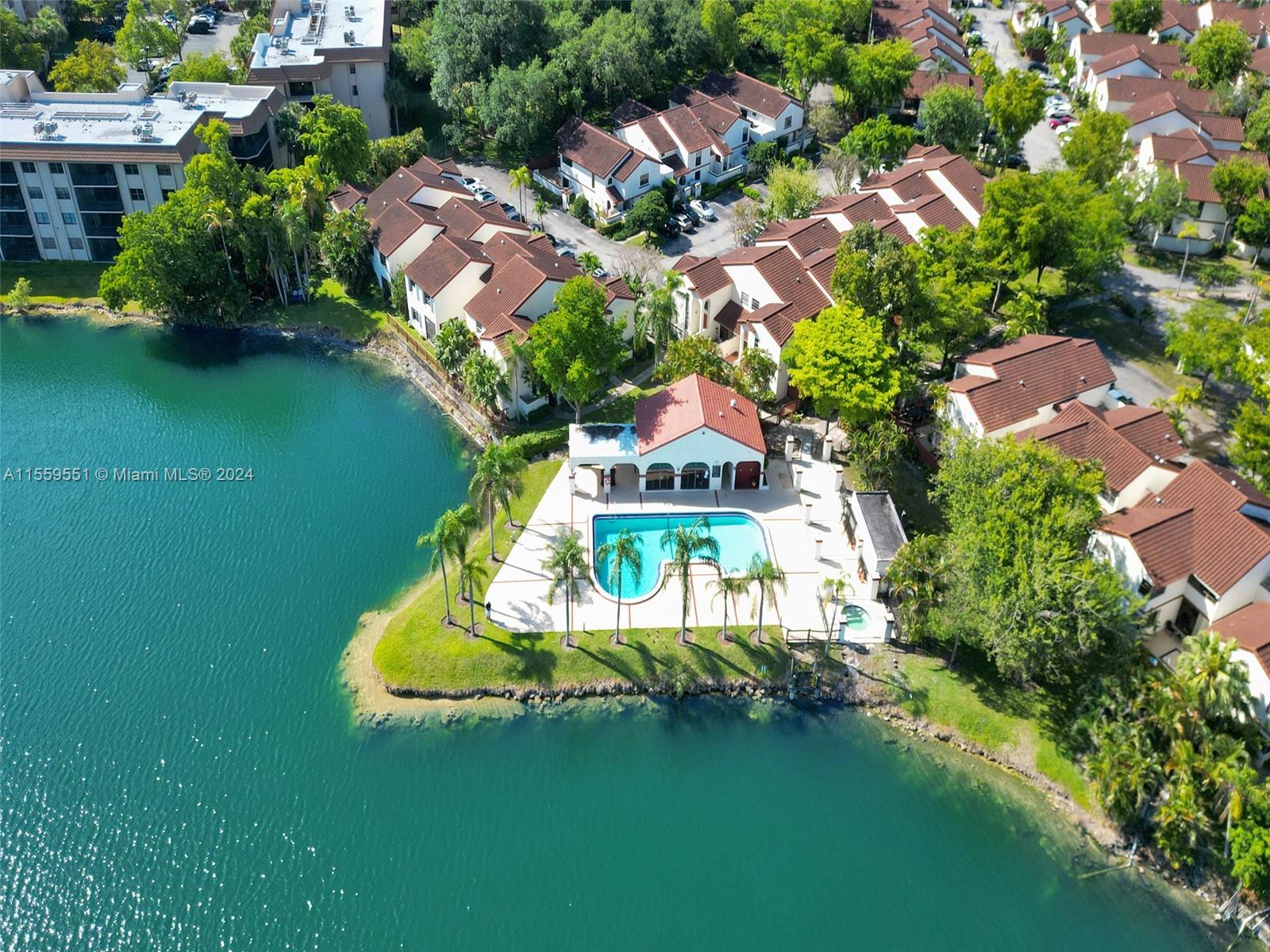 337 Ives Dairy Road, Unit 33704 Miami, FL 33179 - Photo 20 of 22 an aerial view of a house with swimming pool a yard and lake view