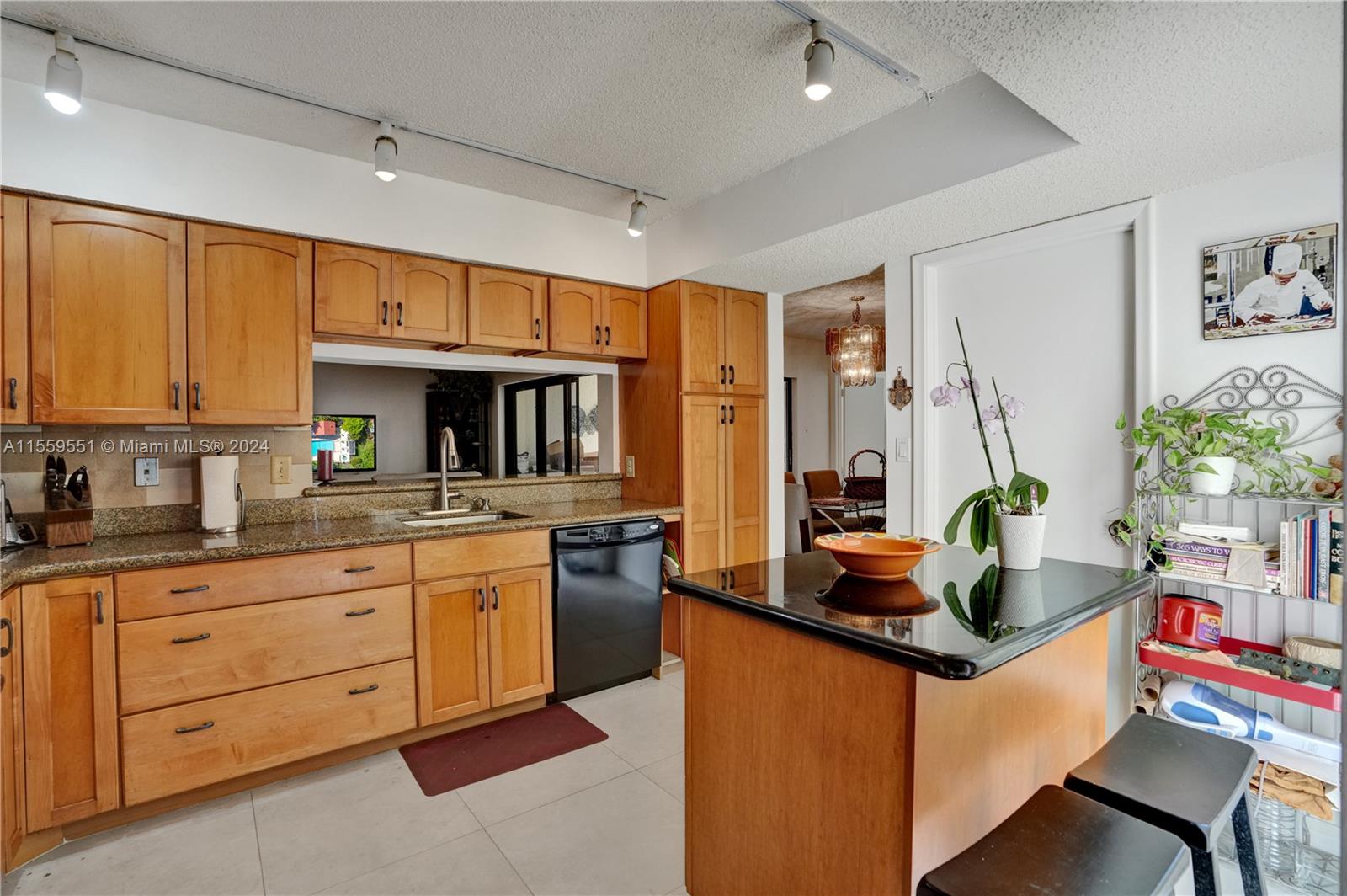 337 Ives Dairy Road, Unit 33704 Miami, FL 33179 - Photo 3 of 22 a kitchen with granite countertop a sink stove and cabinets