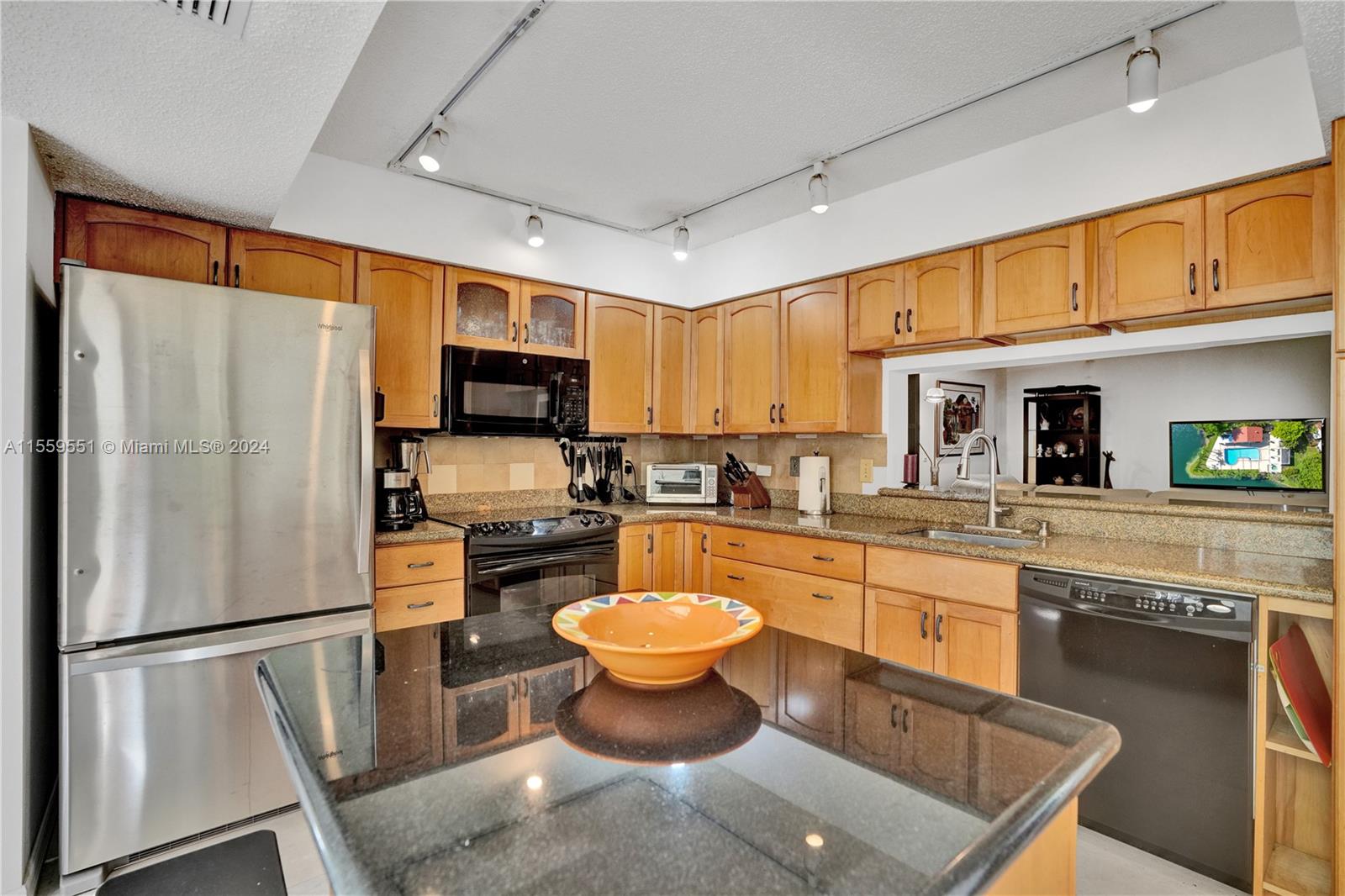 337 Ives Dairy Road, Unit 33704 Miami, FL 33179 - Photo 4 of 22 a kitchen with stainless steel appliances a stove refrigerator sink and microwave