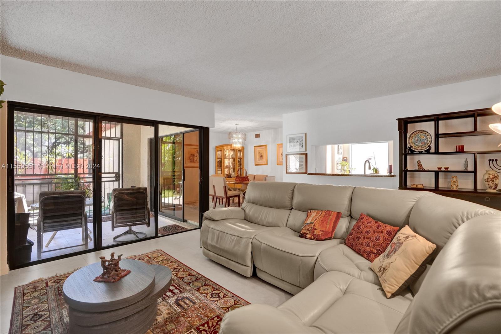 337 Ives Dairy Road, Unit 33704 Miami, FL 33179 - Photo 5 of 22 a living room with furniture and a large window