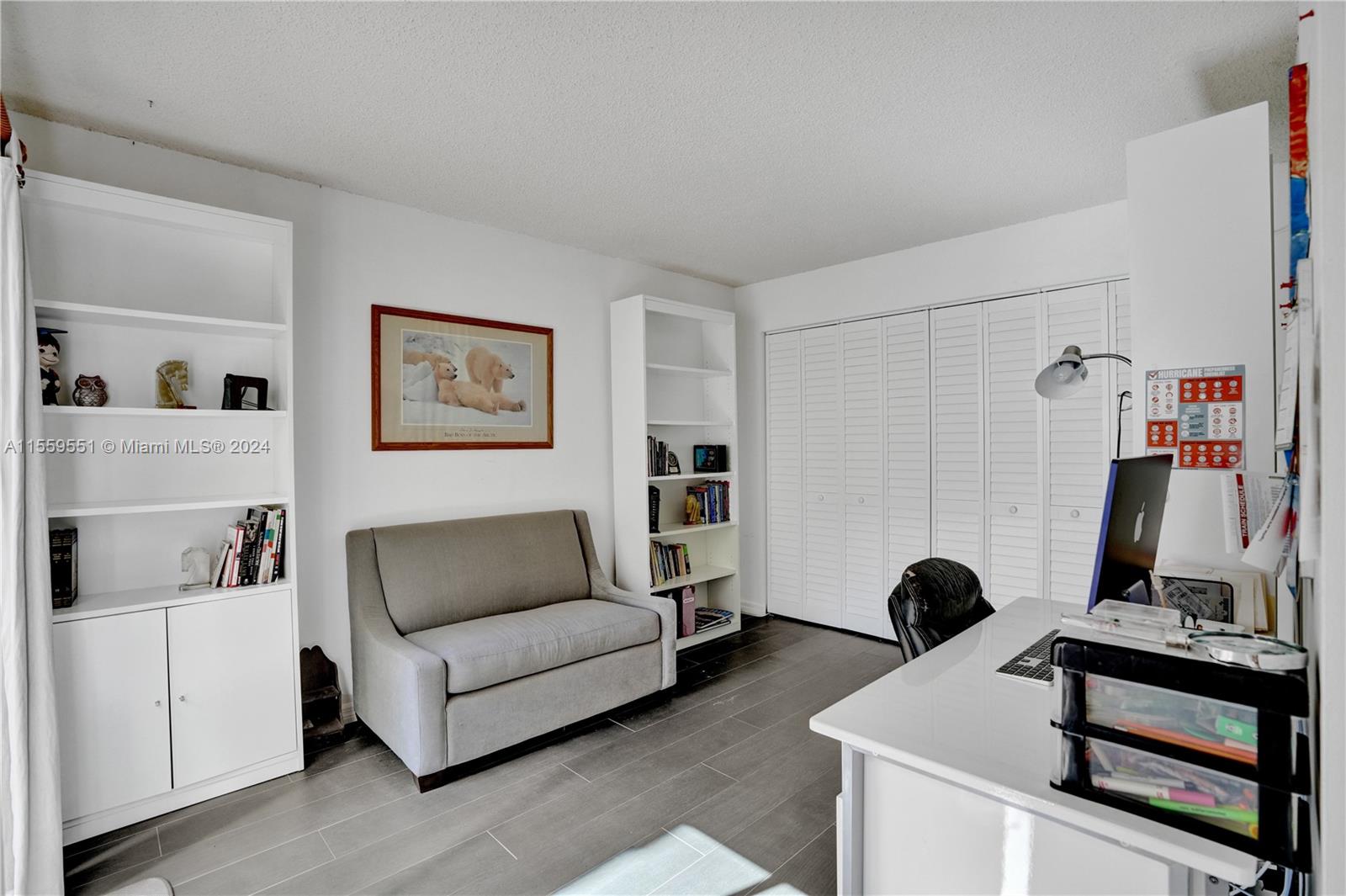337 Ives Dairy Road, Unit 33704 Miami, FL 33179 - Photo 9 of 22 a living room with furniture and a mirror