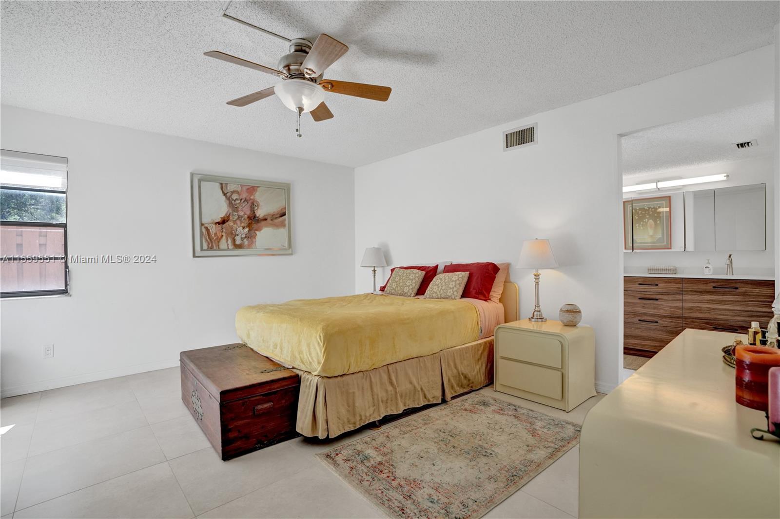 337 Ives Dairy Road, Unit 33704 Miami, FL 33179 - Photo 10 of 22 a bedroom with a bed and a chandelier