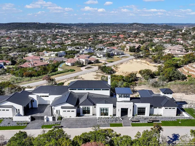 an aerial view of residential houses with outdoor space