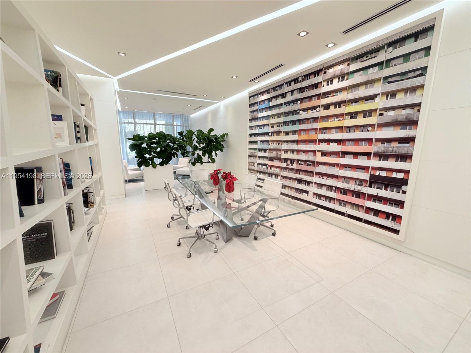 a view of living room filled with furniture and white walls