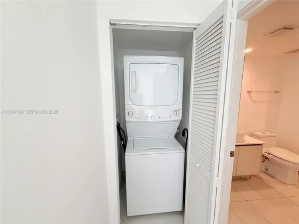 a view of a kitchen with white cabinets