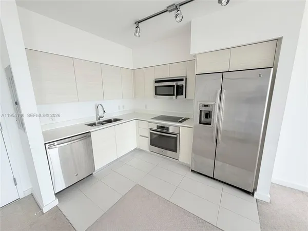 a kitchen with white cabinets and white appliances