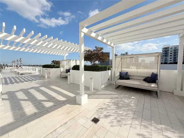 a view of a swimming pool and lounge chairs