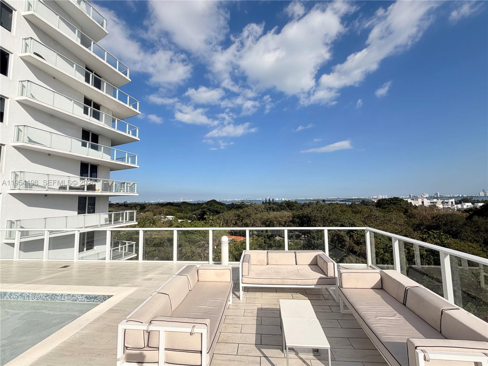 4250 Biscayne Boulevard, Unit 1014 Miami, FL 33137 - Photo 27 of 63 a view of balcony with a large window and wooden fence