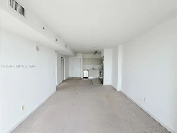 an empty room with windows and closet