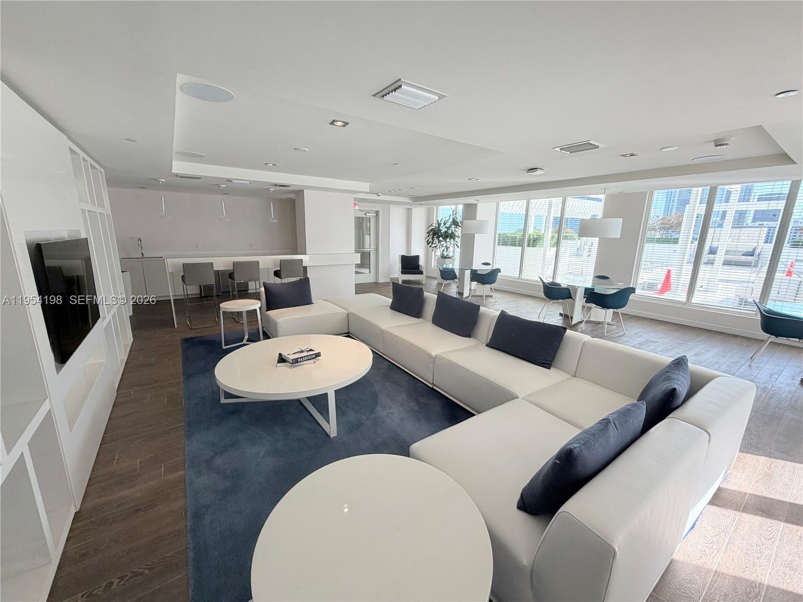 4250 Biscayne Boulevard, Unit 1014 Miami, FL 33137 - Photo 43 of 63 a large living room with furniture a large window and a fireplace