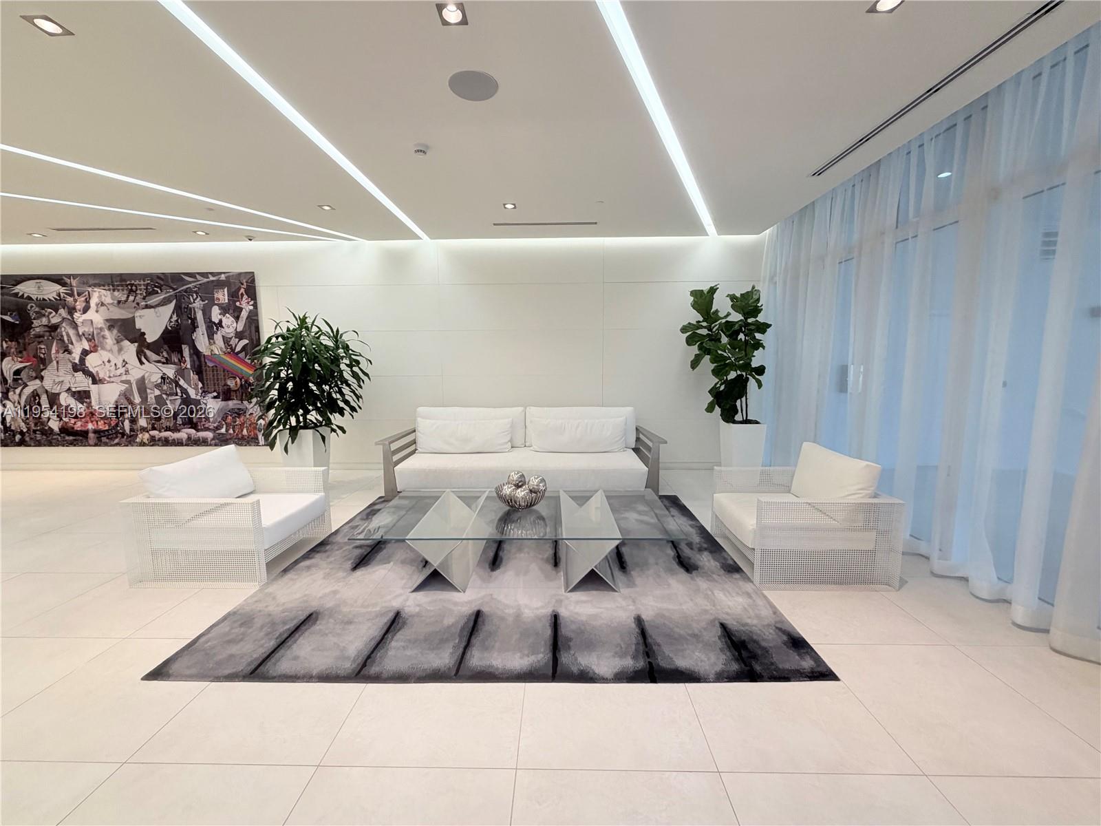 4250 Biscayne Boulevard, Unit 1014 Miami, FL 33137 - Photo 59 of 63 a bedroom with a large bed and a couch