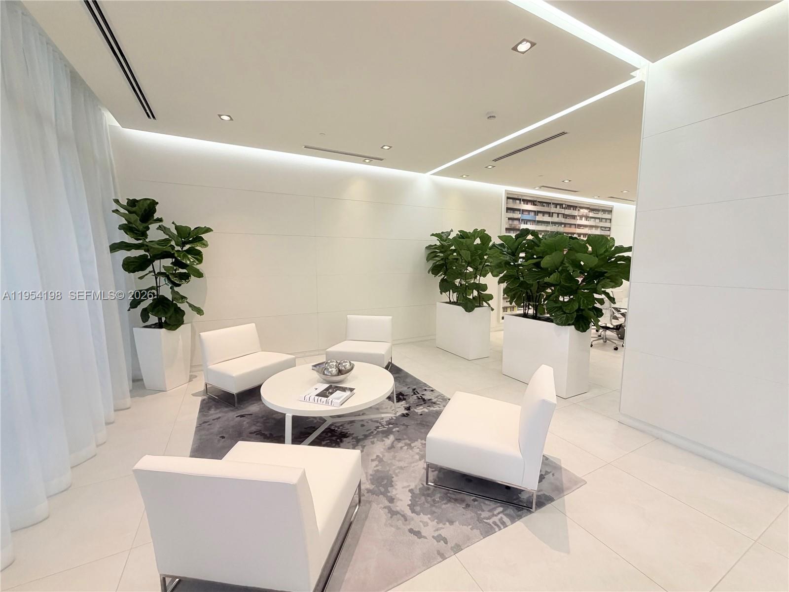 4250 Biscayne Boulevard, Unit 1014 Miami, FL 33137 - Photo 60 of 63 a living room with furniture and flowers