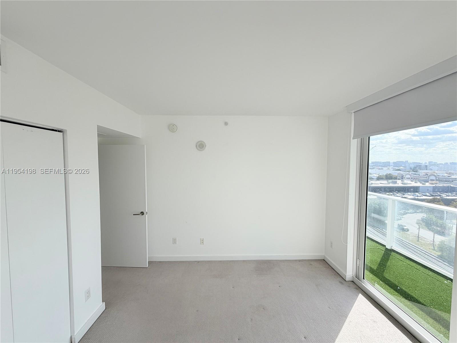 4250 Biscayne Boulevard, Unit 1014 Miami, FL 33137 - Photo 10 of 63 a view of an empty room with a window