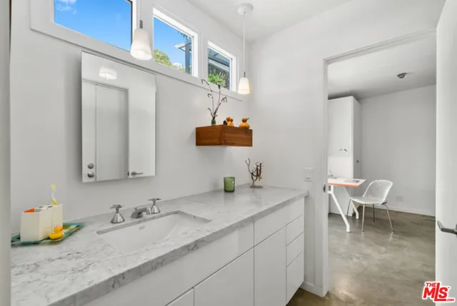 a living room with furniture a rug and a window