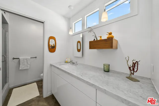 a living room with furniture pool table and a flat screen tv
