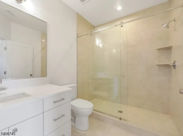 a bathroom with a shower curtain a sink and a large mirror
