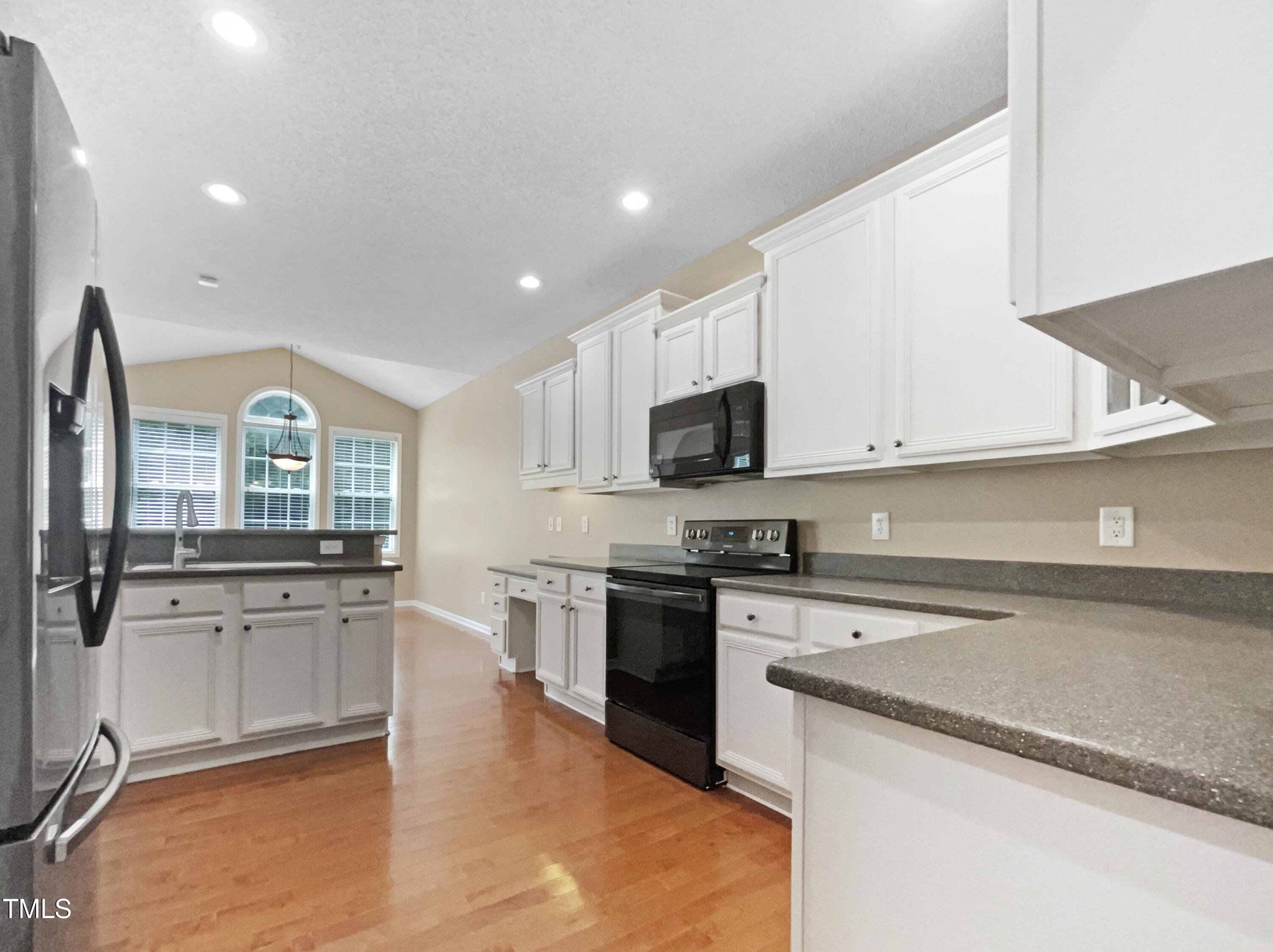 1005 Augustine Trail Cary, NC 27518 - Photo 11 of 19 a kitchen with stainless steel appliances granite countertop a stove and a sink