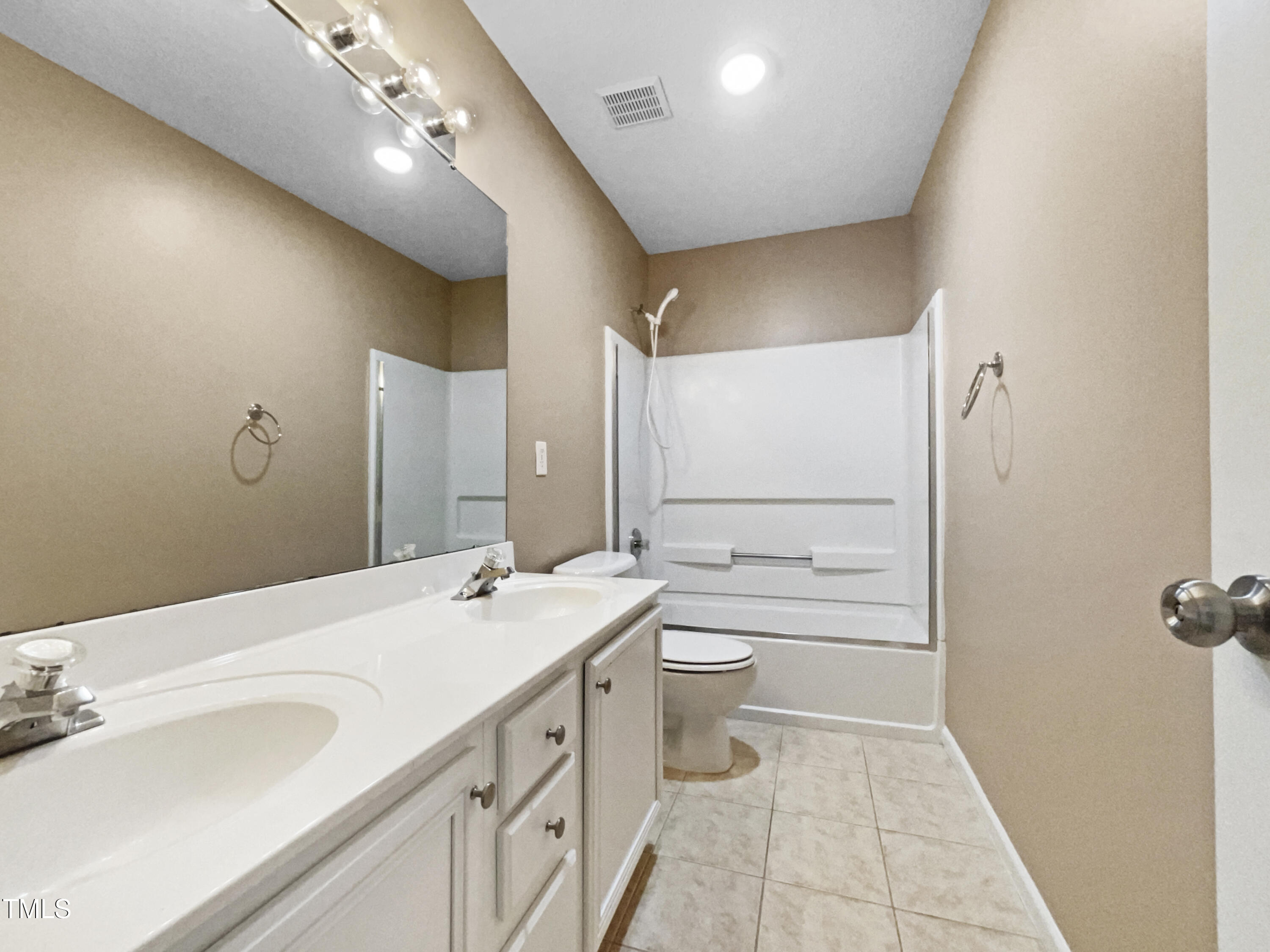 1005 Augustine Trail Cary, NC 27518 - Photo 18 of 19 a bathroom with a double vanity sink toilet mirror and shower