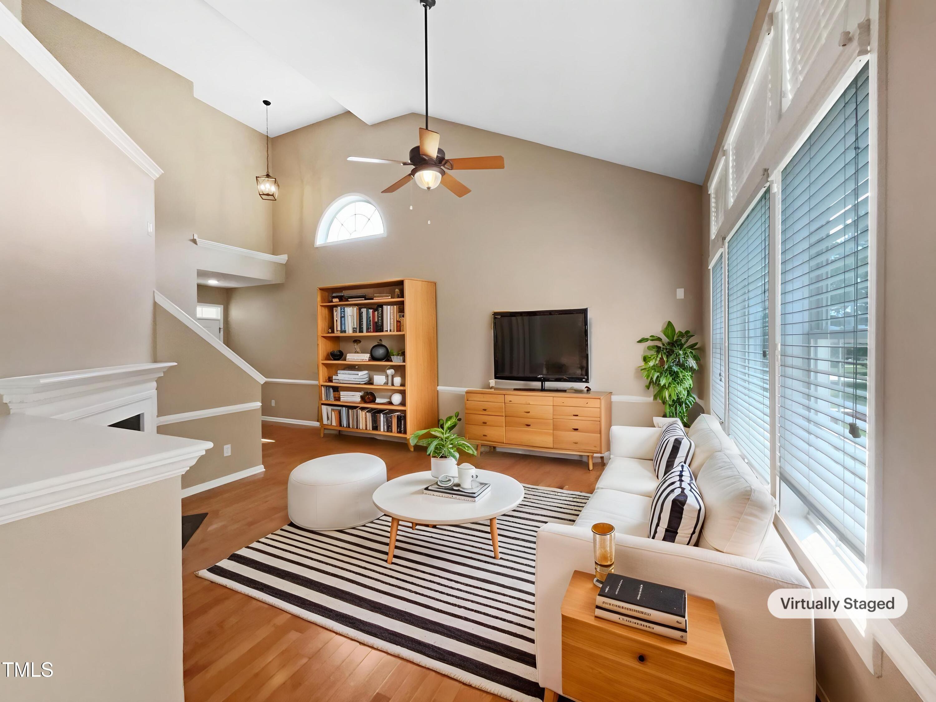 1005 Augustine Trail Cary, NC 27518 - Photo 2 of 19 a living room with furniture a dining table and a fireplace