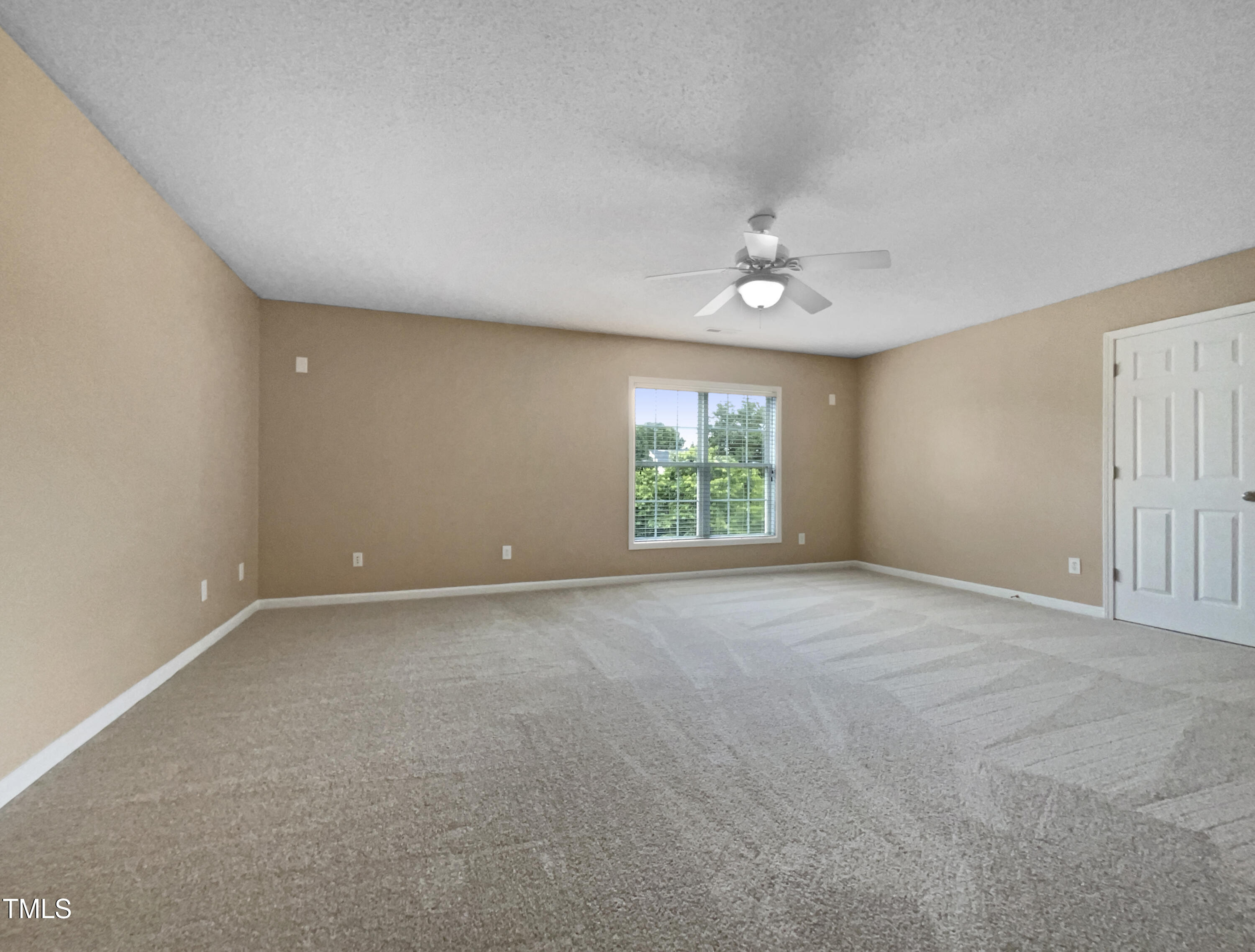 1005 Augustine Trail Cary, NC 27518 - Photo 5 of 19 an empty room with a window and a ceiling fan