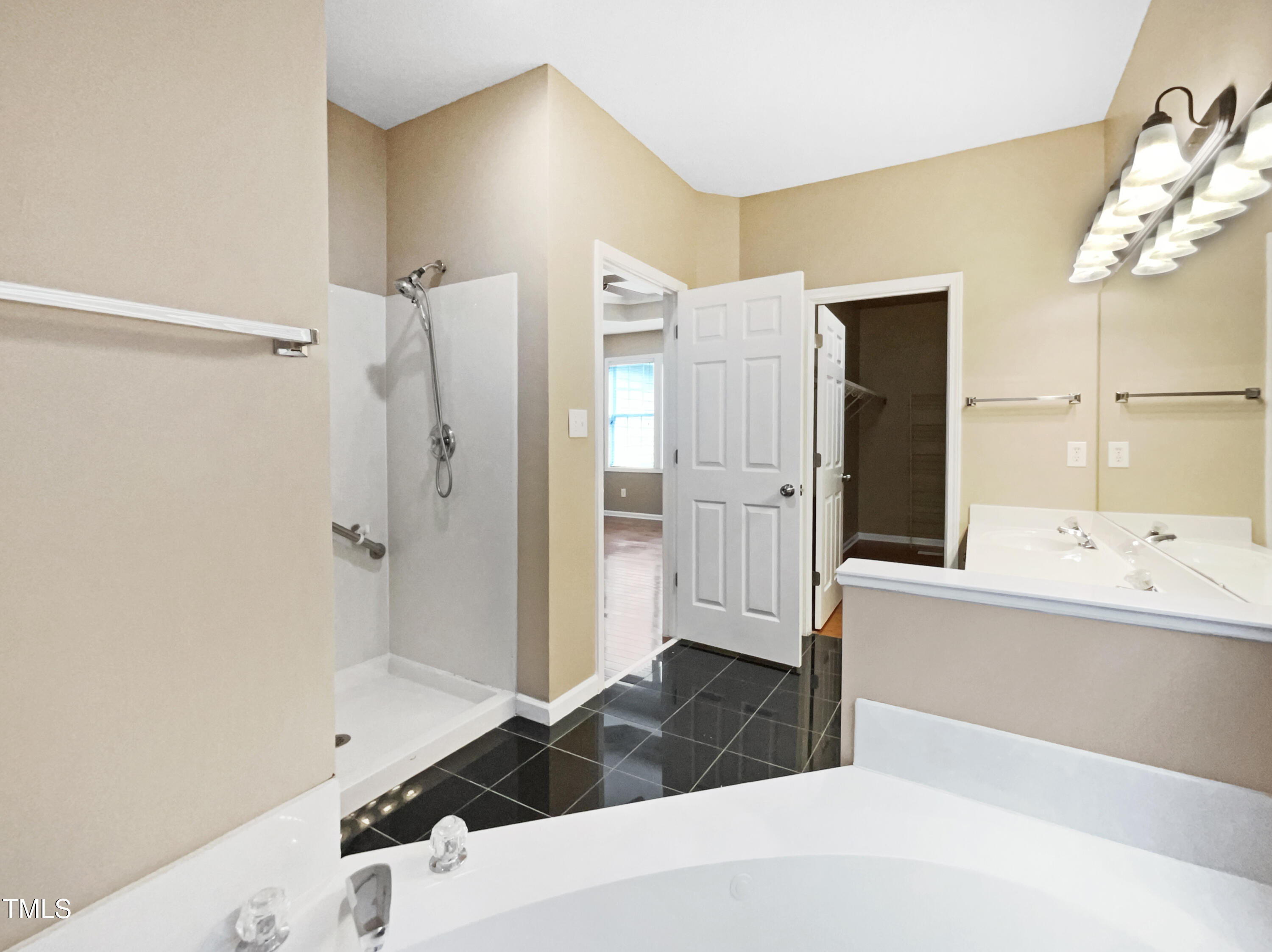 1005 Augustine Trail Cary, NC 27518 - Photo 7 of 19 a bathroom with a tub shower and sink