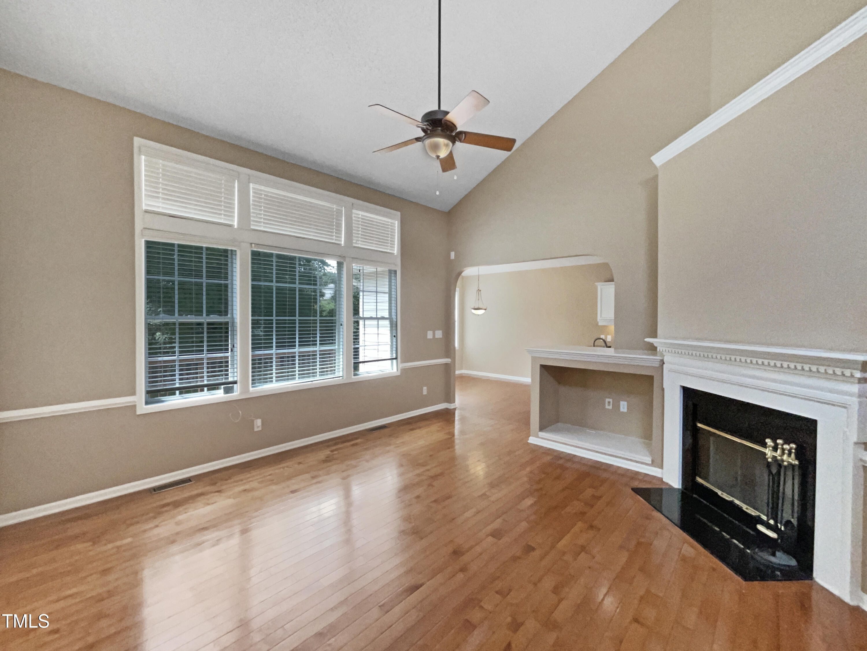 1005 Augustine Trail Cary, NC 27518 - Photo 10 of 19 a view of an empty room with a fireplace and a window