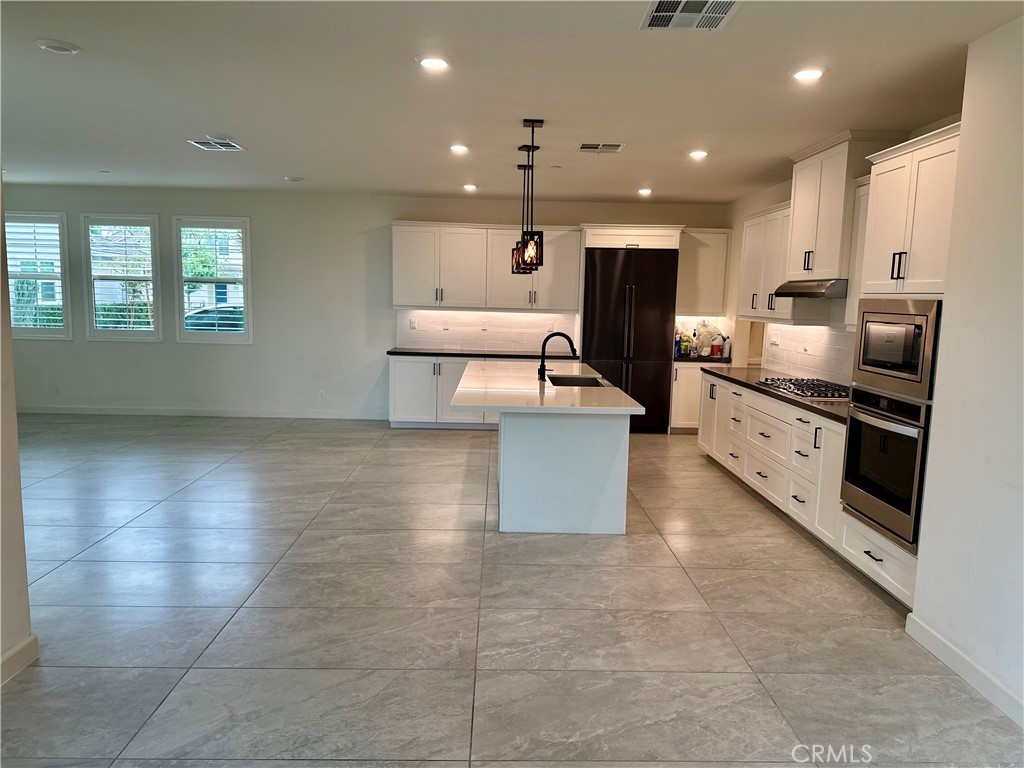 12358 Primrose Avenue Whittier, CA 90602 - Photo 1 of 50 a large kitchen with stainless steel appliances a large counter top and a stove top oven